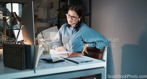 Image of Business woman, computer or back pain in night office, digital marketing startup or advertising agency company. Tired, stress injury or worker on web design technology and sciatica crisis or burnout