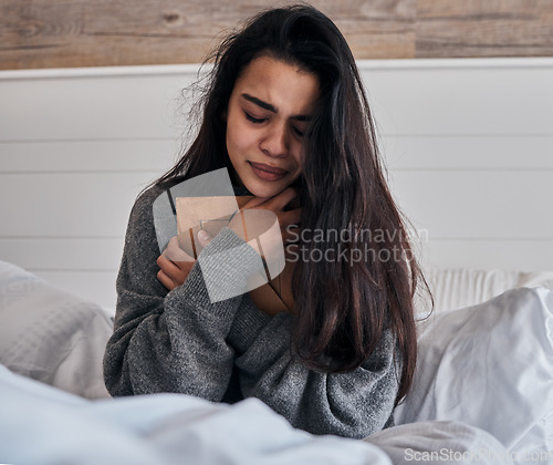 Image of Sad, loss and woman crying with a photo for memory while in bed in the morning. Depression, tears and girl with a picture frame in the bedroom during grief, sadness and sorrow about death in a house