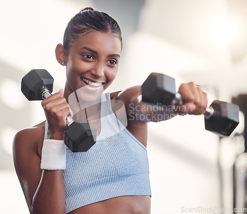 Image of Woman, dumbbell or punching in gym workout, training or exercise in muscle growth, strong body or wellness target goal. Smile, happy or fitness athlete weightlifting heavy metal in Indian health club