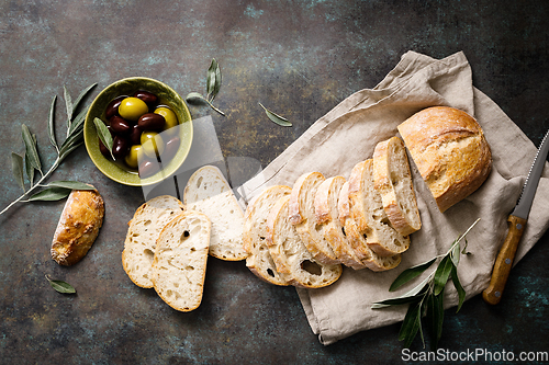 Image of Ciabatta bread sliced on a board, top view