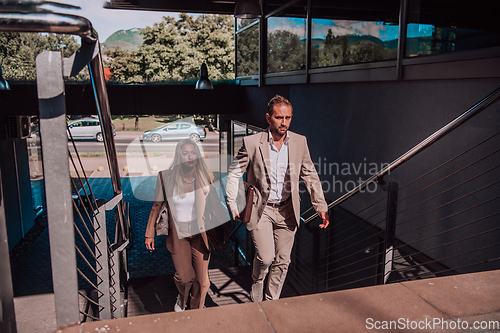 Image of Modern business couple after a long day's work, walking together towards the comfort of their home, embodying the perfect blend of professional success and personal contentment.