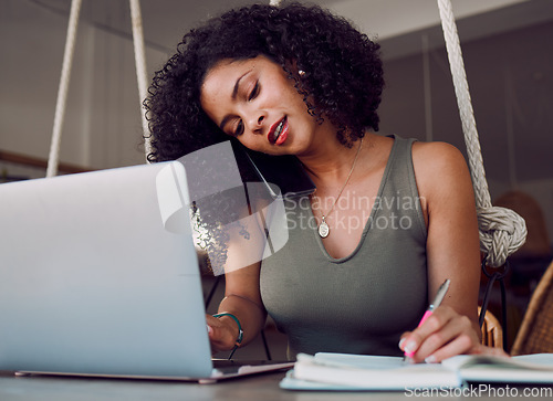 Image of Laptop, phone call and black woman writing in notebook, multitasking and working in cafe. Freelancer, tech and female remote worker with computer, books and mobile smartphone networking with contact.