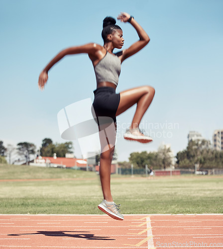 Image of Fitness, jump or black woman runner on a race track in training, cardio workout or sports exercise in summer. Jumping, running and healthy African girl sprinter on a mission for goals in a stadium