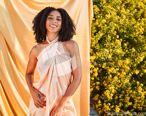 Image of Beauty, fashion and portrait of black woman in garden on outdoor shoot with silk fabric backdrop and plants in summer sun. Elegance, glamour and happy woman with afro, smile and nature in background.