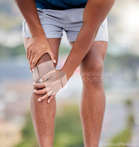 Image of Man, legs and running injury in nature park for wellness exercise, medical accident or sports emergency. Black man, athlete and runner knee pain, joint pain or orthopedic arthritis pain in outdoors