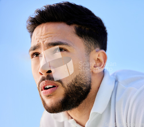 Image of Face, fitness and sports man in nature ready for workout, exercise or training. Blue sky, healthcare and serious male athlete from Canada with focus, vision or thinking about exercising outdoors.