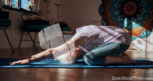 Image of Senior woman, stretching and yoga exercise in living room for fitness, cardio and wellness on mat studio training. Retirement, workout and pilates elderly retired person exercising legs on floor