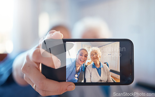 Image of Phone, nurse and happy old woman take a selfie on screen after consulting with medical doctor. Photo, caregiver and healthy senior person in retirement take pictures for social media in nursing home