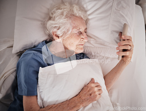 Image of Bad vision, senior woman and phone on bed in bedroom home texting, social media or internet browsing. Blurred eyesight, retired and elderly female with smartphone squinting and trying to read message