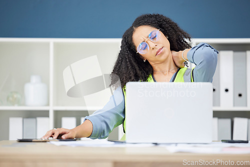 Image of Woman architect, laptop and neck pain in stress, burnout or overworked at the office. African American female employee suffering from neck ache, inflammation or spasm working on computer at workplace