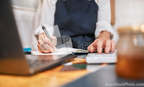 Image of Finance, accounting and hands writing a budget for marketing or advertising a small business startup. Notebook, calculator and entrepreneur working on financial data analysis or sales growth goals