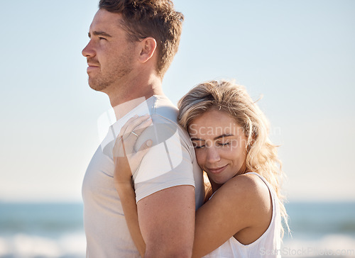 Image of Couple, hug and love bonding on beach by ocean or sea in trust, support or security on summer holiday in tropical Bali travel location. Smile, happy or embrace for man and woman on nature honeymoon