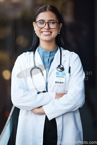 Image of Healthcare, doctor and portrait of woman with smile and glasses in hospital lobby on happy mission to help. Proud female leader in medical field with vision, trust and leadership at clinic in India.