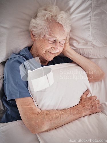 Image of Relax, bedroom and old woman sleeping in peace resting in a house or home dreaming with a soft pillow in hand. Bedding, healthy grandmother or tired elderly person in retirement enjoys napping alone