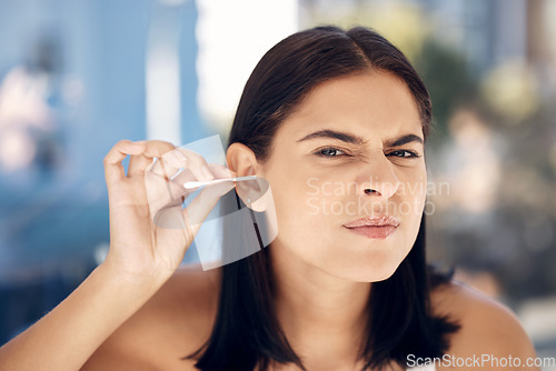 Image of Ear, cleaning and woman in a bathroom for grooming, hygiene and daily routine with cotton buds on blurred background. Face, girls and earwax removal for wellness, gresh and body care in India