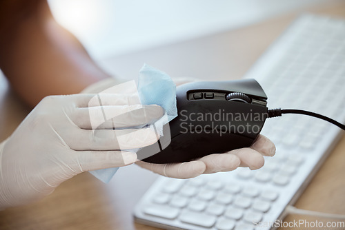 Image of Computer mouse, hand and wipe to disinfect during covid for health, government compliance and wellness at workplace. Gloves on woman at office for covid 19 virus sanitizer and cleaning of equipment