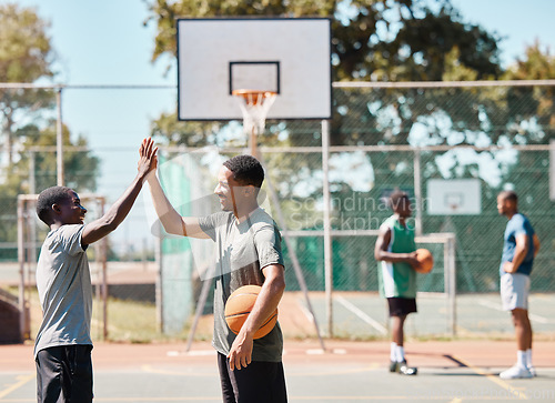 Image of Basketball court, high five and team sports, success and support, winners and achievement outdoor. Excited basketball player community, men and friends, celebration goals and competition motivation