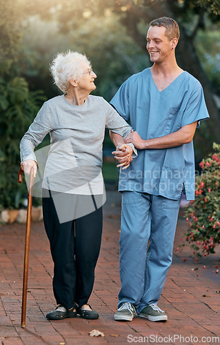 Image of Nurse, senior woman and walking in park for healthcare and wellness. Physiotherapy, rehabilitation and retired elderly female with disability and cane talking to medical worker outdoors in garden.