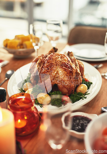 Image of Thanksgiving, food and celebration with a turkey serving on a table in a home for tradition in the holidays. Christmas, chicken and eating with a meal served on a wooden surface from above for dining