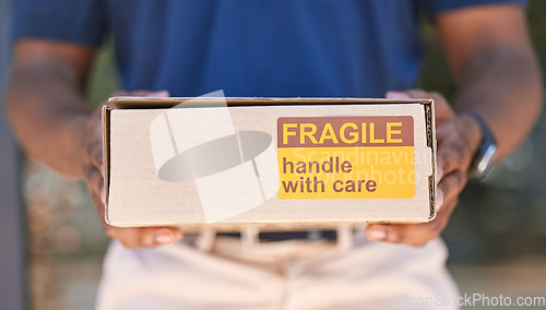 Image of Hands, logistics and box for special delivery, cargo or handle with care sign for shipping. Hand in deliver holding fragile cardboard box packaging for online purchase, export or courier service