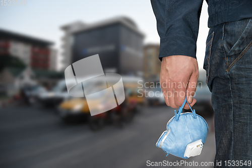 Image of A man in the city with medical mask