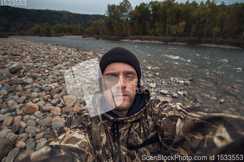 Image of Caucasian man in the mountain making selfie