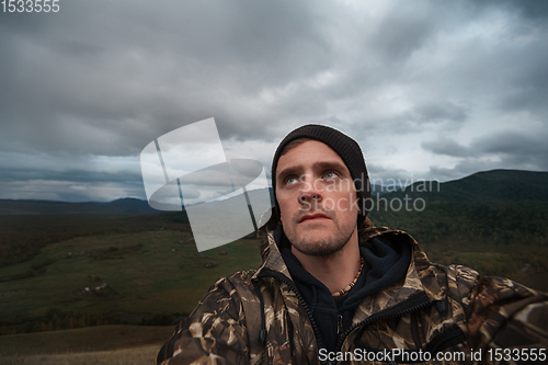 Image of Caucasian man in the mountain making selfie