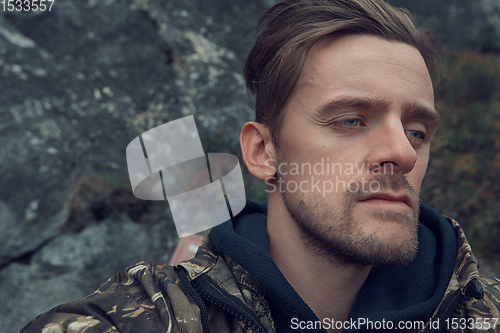 Image of Caucasian man in the mountain making selfie