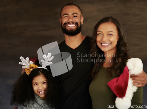 Image of Christmas, hug and portrait of a family with love, care and smile during holiday celebration in their house. Affection, happiness and girl with mother and father to celebrate xmas in their home