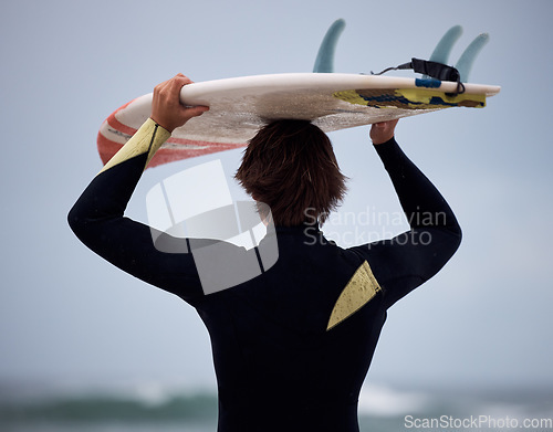 Image of Surfer, surfboard and surfing ocean on waves for fitness exercise, leisure and water sport training exercise. Beach surf, man in wetsuit and fun sea freedom workout in Australia for summer wellness