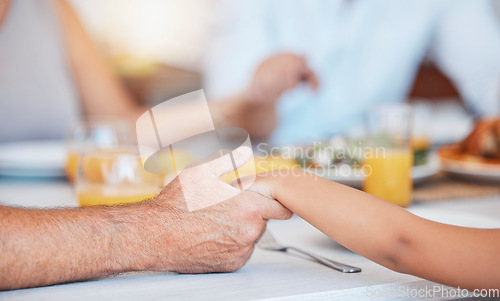 Image of Family, hands and gratitude prayer for food at table together for faith, religion and appreciation. Christian, child and senior man holding hands to give thanks and pray to God for lunch.
