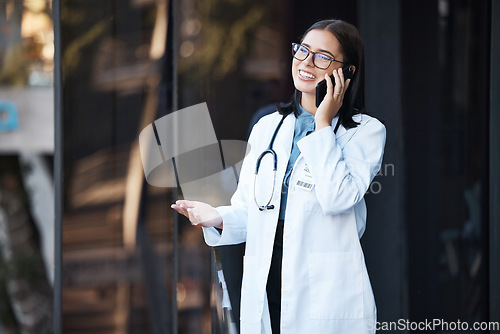 Image of Doctor, phone call and talking for communication, funny conversation and telehealth with contact outdoor in the city. Medical worker, healthcare expert or woman speaking on mobile smartphone on break