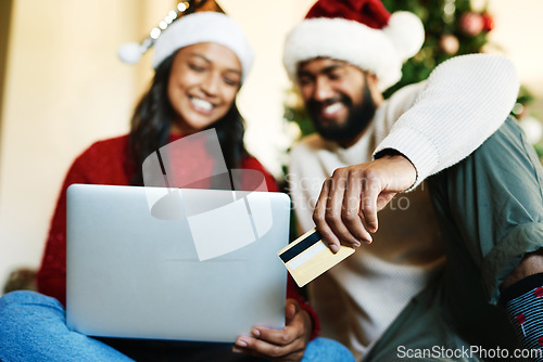 Image of Laptop, credit card and couple online shopping on Christmas day in home living room. Xmas holiday, fintech and happy man and woman on computer, internet shop or virtual store buying gifts or presents