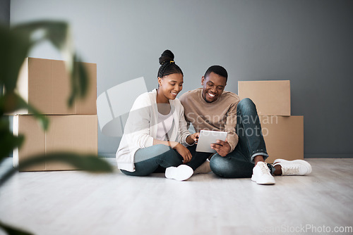 Image of Real estate, property and black couple with boxes and tablet for furniture shopping or search renovating ideas. Happy owners, relocation and tenants on digital touchscreen on moving day in new home.