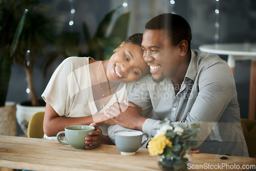 Image of Cafe, love and happy black couple on a date hugging, talking or holding hands while drinking coffee or tea. Happiness, relaxing and romantic black woman enjoys quality time with African partner