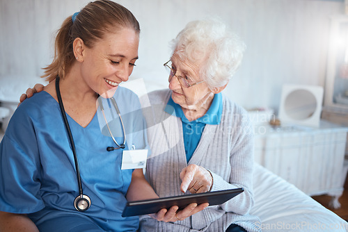 Image of Tablet, nurse or doctor consulting an old woman in a nursing home bedroom with blood pressure and heart test results. Smile, trust and happy healthcare worker with a senior persons medical report