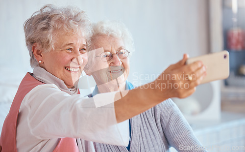 Image of Phone, selfie and elderly friends smile for pictures to share on social media online while relaxing in retirement. Happy, love and senior women smiling while enjoy quality time at home in Berlin