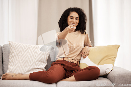 Image of Tv, portrait and woman relax on sofa, happy and smile while channel surfing in living room at home. Black woman, remote control and watching tv on a couch, excited about weekend freedom in her house