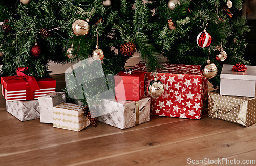 Image of Christmas, floor and box of gift by tree for celebration, festive season and party. Xmas, surprise and gratitude with present on ground of living room with nobody for wow, announcement and holiday