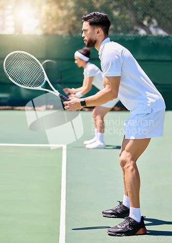 Image of Fitness, teamwork and couple in a tennis partnership for a doubles workout game or training match in summer. Wellness, focus and healthy man playing on a tennis court outdoors with a sports partner