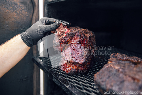 Image of Meat grilling on the smoker