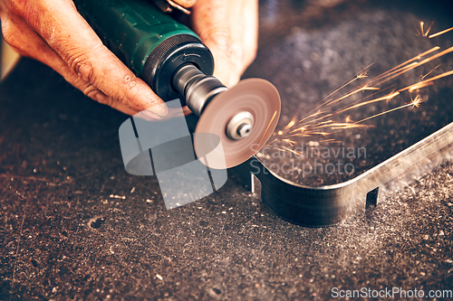 Image of Worker cuts metal with metal sawing