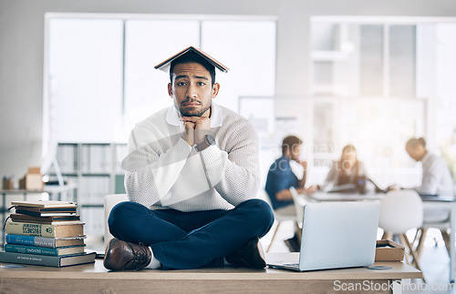 Image of Business man, books and learning with a frustrated, sad and tired entrepreneur on desk for burnout, stress and anxiety. Portrait of a bored law student and employee in office to study, learn and work