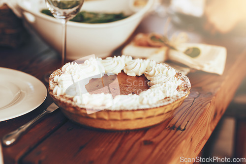 Image of Pumpkin pie, food and table set for lunch on dinning table in home. Fine dining, cake or pastry for buffet, brunch or thanksgiving party, festive celebration or luxury dessert, meal or dish in house