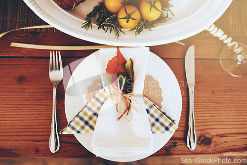 Image of Plate, Christmas and celebration with a table setting on a wooden surface in the festive season from above. Party, still life and cutlery with a napkin on a serving dish in an empty home with flare