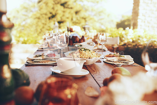 Image of Food, celebration and dinner party in a garden for fine dining, nutrition and table setting. Lunch, celebration and tradition on a patio with a prepared dinner on a table in the backyard of a house