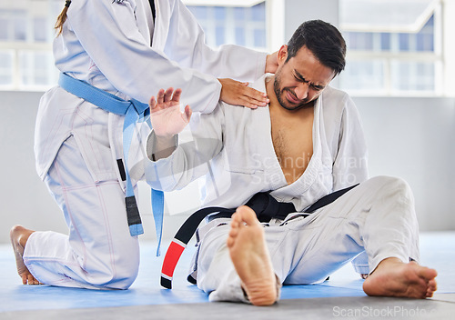 Image of Karate, sports and neck injury pain of fighter on floor with surrender hand at professional athlete club. Accident, help and tournament of martial arts person in agony with muscle pain.