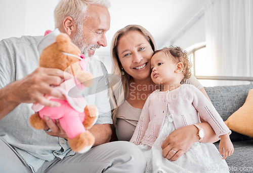Image of Children, family and teddy bear with a girl and grandparents playing on the sofa during a visit in their home. Kids, love and toys with a senior man and woman bonding together with their grandchild