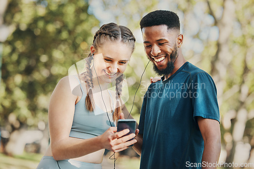 Image of Phone, music and fitness with a diversity couple streaming audio while running in the park for exercise. Nature, social media and workout with a sports man and woman listening to the radio together