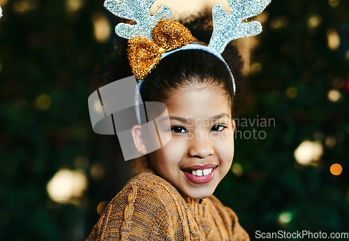 Image of Christmas, portrait and children with a girl in antlers on a dark background for festive season celebration. Face, smile and kids with a female child wearing reindeer horns headwear in the holidays
